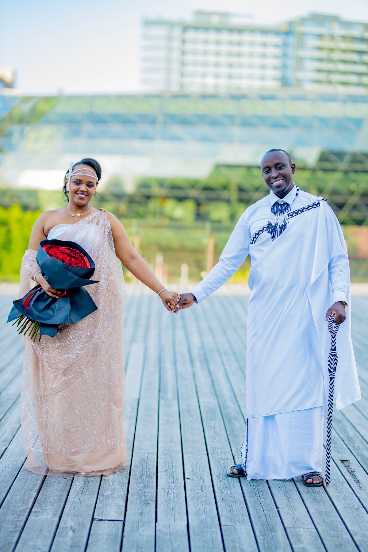 Hope and Arsene in traditional attire on the boardwalk